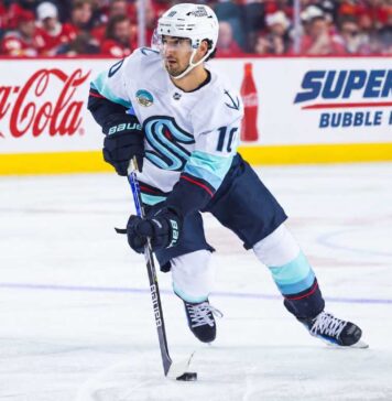 Matty Beniers Seattle Kraken 2026-27 fantasy hockey projection with Coca-Cola and Super Chexx Bubble Hockey rink board ads