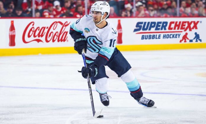 Matty Beniers Seattle Kraken 2026-27 fantasy hockey projection with Coca-Cola and Super Chexx Bubble Hockey rink board ads