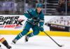 Michael Misa Point Projections 2026-27: San Jose Sharks Fantasy Outlook Michael Misa skating for the San Jose Sharks beside a Super Chexx Pro bubble hockey board ad in a 2026-27 fantasy hockey point projection.