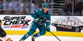 Michael Misa skating for the San Jose Sharks beside a Super Chexx Pro bubble hockey board ad in a 2026-27 fantasy hockey point projection.