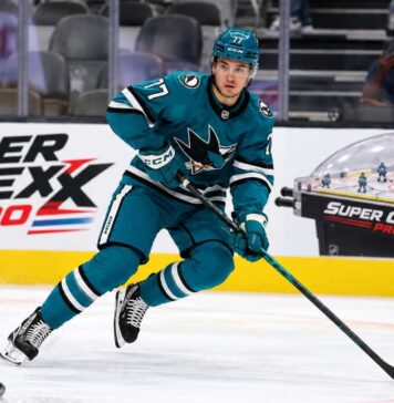 Michael Misa skating for the San Jose Sharks beside a Super Chexx Pro bubble hockey board ad in a 2026-27 fantasy hockey point projection.