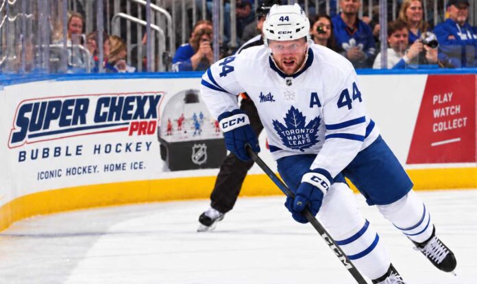 morgan-rielly-maple-leafs-trade-rumors-2026 Morgan Rielly skating for the Toronto Maple Leafs amid trade rumors about his future in Toronto.