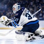 NHL News Today: Hellebuyck Trade Market Heats Up as Maple Leafs Add Brisson Connor Hellebuyck in Winnipeg Jets gear making a save during a game as NHL trade rumors and today’s NHL News spotlight his future
