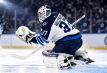 NHL News Today: Hellebuyck Trade Market Heats Up as Maple Leafs Add Brisson Connor Hellebuyck in Winnipeg Jets gear making a save during a game as NHL trade rumors and today’s NHL News spotlight his future