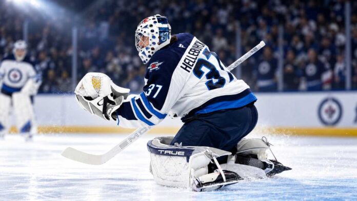 nhl-news-rumors-september-4-2026 Connor Hellebuyck in Winnipeg Jets gear making a save during a game as NHL trade rumors and today’s NHL News spotlight his future