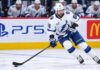 Nikita Kucherov Rumors: Why Has Tampa Bay Still Not Signed Its Superstar? Tampa Bay Lightning star forward skating with the puck in a game action shot with PS5 and McDonald’s ads on the boards in the background