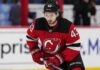 Quinn Hughes Trade Rumors: Could Contract Uncertainty Finally Give the Devils Their Opening? Quinn Hughes wearing a New Jersey Devils home jersey amid NHL trade rumors involving the Minnesota Wild and New Jersey Devils.