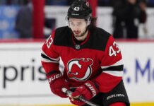 Quinn Hughes Trade Rumors: Could Contract Uncertainty Finally Give the Devils Their Opening? Quinn Hughes wearing a New Jersey Devils home jersey amid NHL trade rumors involving the Minnesota Wild and New Jersey Devils.