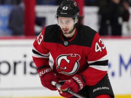 Quinn Hughes Trade Rumors: Could Contract Uncertainty Finally Give the Devils Their Opening? Quinn Hughes wearing a New Jersey Devils home jersey amid NHL trade rumors involving the Minnesota Wild and New Jersey Devils.