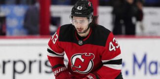 Quinn Hughes Trade Rumors: Could Contract Uncertainty Finally Give the Devils Their Opening? Quinn Hughes wearing a New Jersey Devils home jersey amid NHL trade rumors involving the Minnesota Wild and New Jersey Devils.