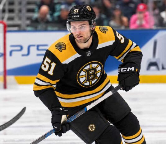 Boston Bruins Trade Rumors: Should Boston Make Its Move for Shane Wright? Shane Wright wearing a Boston Bruins home jersey amid NHL trade rumors involving the Seattle Kraken