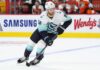 Seattle Kraken forward controls the puck during NHL action as Shane Wright trade rumors continue to generate buzz around Seattle