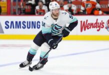 Seattle Kraken forward controls the puck during NHL action as Shane Wright trade rumors continue to generate buzz around Seattle