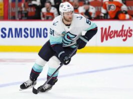 Seattle Kraken forward controls the puck during NHL action as Shane Wright trade rumors continue to generate buzz around Seattle