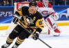 Sidney Crosby Trade Rumors: Did He Just Close the Door on a Canadiens or Avalanche Blockbuster? Sidney Crosby skating in a Pittsburgh Penguins home jersey with a Montreal Canadiens goalie in the background and a PS5 rink-board advertisement.