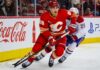 Zach Whitecloud Trade Rumors: Are the Canadiens Quietly Circling Calgary’s Most Valuable Trade Chip? Zach Whitecloud of the Calgary Flames battles a Montreal Canadiens player as trade rumors link Whitecloud to Montreal.