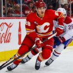 Zach Whitecloud Trade Rumors: Are the Canadiens Quietly Circling Calgary’s Most Valuable Trade Chip? Zach Whitecloud of the Calgary Flames battles a Montreal Canadiens player as trade rumors link Whitecloud to Montreal.