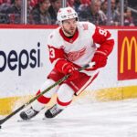 Alex DeBrincat Trade Rumors: Is Detroit’s Chaos About to Put Another Star in Play? Alex DeBrincat skating for the Detroit Red Wings as NHL trade rumors grow around his contract future in Detroit.