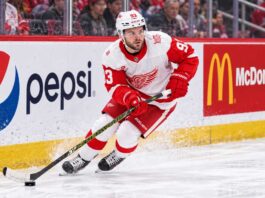 Alex DeBrincat skating for the Detroit Red Wings as NHL trade rumors grow around his contract future in Detroit.