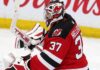 NHL News Today: Hellebuyck Trade, NHL Rumors and Scores — October 24, 2026 Connor Hellebuyck wearing a New Jersey Devils home jersey, red and black goalie equipment and Devils-themed mask in an edited image illustrating his blockbuster trade from the Winnipeg Jets in October 2026.