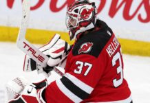 NHL News Today: Hellebuyck Trade, NHL Rumors and Scores — October 24, 2026 Connor Hellebuyck wearing a New Jersey Devils home jersey, red and black goalie equipment and Devils-themed mask in an edited image illustrating his blockbuster trade from the Winnipeg Jets in October 2026.
