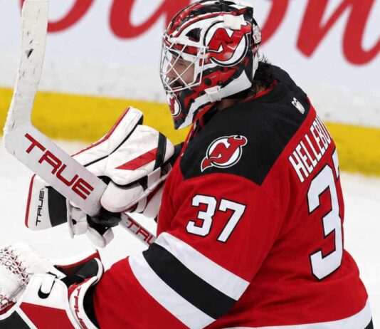 Connor Hellebuyck wearing a New Jersey Devils home jersey, red and black goalie equipment and Devils-themed mask in an edited image illustrating his blockbuster trade from the Winnipeg Jets in October 2026.