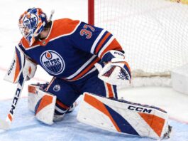Connor Hellebuyck wearing Edmonton Oilers goalie gear amid NHL trade rumors linking the Winnipeg Jets star to Edmonton.
