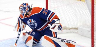 Connor Hellebuyck wearing Edmonton Oilers goalie gear amid NHL trade rumors linking the Winnipeg Jets star to Edmonton.