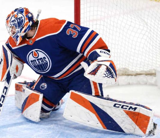 Connor Hellebuyck wearing Edmonton Oilers goalie gear amid NHL trade rumors linking the Winnipeg Jets star to Edmonton.