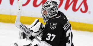 Connor Hellebuyck wearing a Los Angeles Kings jersey and goalie equipment in a conceptual image illustrating NHL trade rumors linking the Winnipeg Jets star goaltender to Los Angeles.