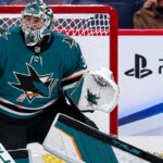Connor Hellebuyck Would Consider the Sharks: So Why Hasn’t Winnipeg Made the Trade? Connor Hellebuyck in a San Jose Sharks uniform amid NHL trade rumors linking the Winnipeg Jets goalie to San Jose