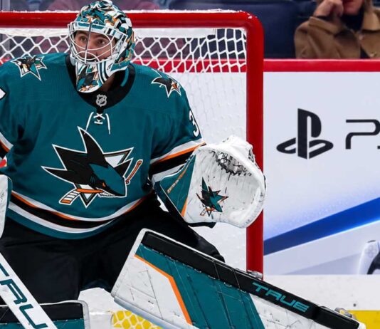 Connor Hellebuyck in a San Jose Sharks uniform amid NHL trade rumors linking the Winnipeg Jets goalie to San Jose
