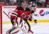 Connor Hellebuyck wearing a New Jersey Devils home jersey and red, black and white goalie equipment following his blockbuster NHL trade from the Winnipeg Jets on October 23, 2026.