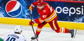 Canucks Eye Connor Zary After 31 NHL Teams Passed — What Does Vancouver See? Calgary Flames forward Connor Zary (#47) skating with the puck against Vancouver Canucks Elias Pettersson in an away jersey, with a Pepsi advertisement on the boards, amid NHL trade rumors linking Zary to Vancouver.