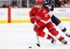 Dylan Larkin Trade Rumors: Did Detroit’s Wild Scouting Trips Change Everything? Dylan Larkin of the Detroit Red Wings wearing his red No. 71 jersey and helmet, skating with the puck amid NHL trade rumors linking him to the Minnesota Wild.