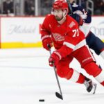 Dylan Larkin Trade Rumors: Did Detroit’s Wild Scouting Trips Change Everything? Dylan Larkin of the Detroit Red Wings wearing his red No. 71 jersey and helmet, skating with the puck amid NHL trade rumors linking him to the Minnesota Wild.