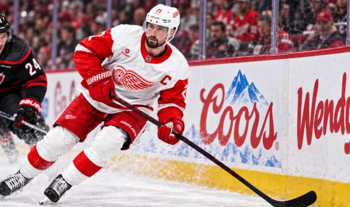 dylan-larkin-detroit-red-wings-trade-rumors-home-opener-boos-2026 Dylan Larkin skates for the Detroit Red Wings amid NHL trade rumors after being booed during the 2026 home opener.