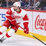 Dylan Larkin skating for the Detroit Red Wings as trade rumors continue following his opening-week injury.