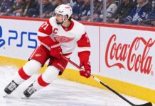 Dylan Larkin skating for the Detroit Red Wings as trade rumors continue following his opening-week injury.