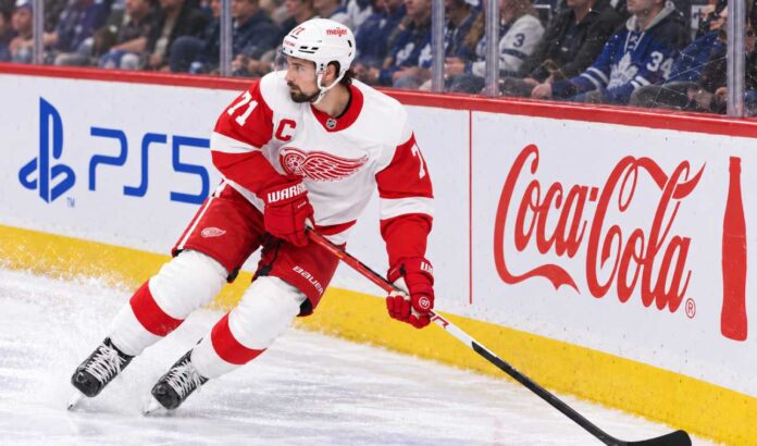 dylan-larkin-detroit-red-wings-trade-rumors-injury-2026 Dylan Larkin skating for the Detroit Red Wings as trade rumors continue following his opening-week injury.