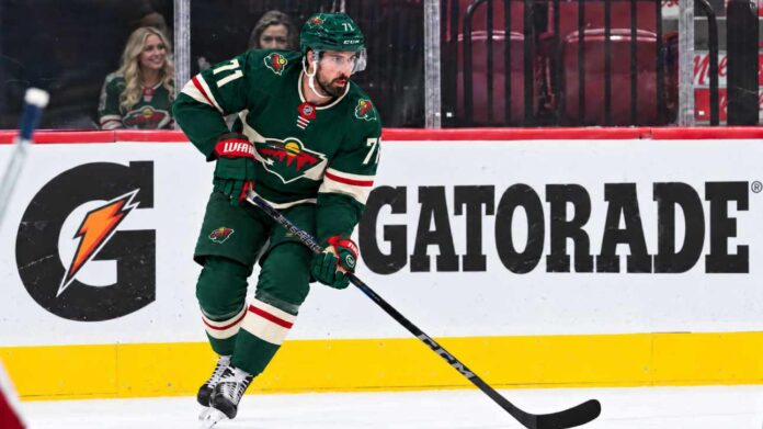 dylan-larkin-minnesota-wild-detroit-red-wings-trade-rumors Dylan Larkin wearing a Minnesota Wild home jersey in a trade rumor concept image as the Detroit Red Wings reportedly scout Minnesota ahead of a potential NHL blockbuster.