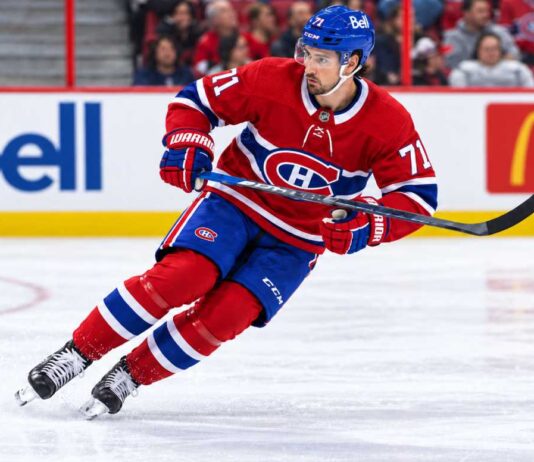 Dylan Larkin pictured in a Montreal Canadiens home jersey amid NHL trade rumors linking the Detroit Red Wings captain to a potential blockbuster trade with Montreal.