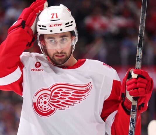 Dylan Larkin wearing Detroit Red Wings No. 71 uniform during an NHL game, as his October 2026 suspension and salary losses dominate Red Wings trade news.