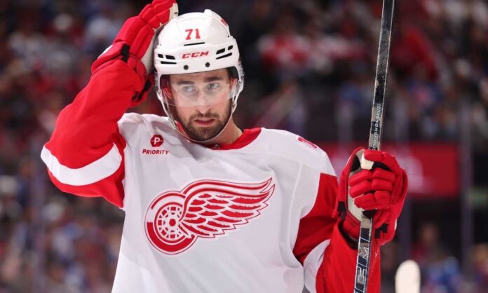 dylan-larkin-red-wings-suspension-salary-loss-2026 Dylan Larkin wearing Detroit Red Wings No. 71 uniform during an NHL game, as his October 2026 suspension and salary losses dominate Red Wings trade news.