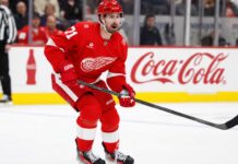 Dylan Larkin Held Out as Red Wings Trade Talks Escalate: Four Teams Emerge Detroit Red Wings centre Dylan Larkin skates during an NHL game as trade negotiations involving several teams intensify.