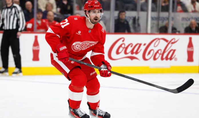 dylan-larkin-red-wings-trade-rumors-2026 Detroit Red Wings centre Dylan Larkin skates during an NHL game as trade negotiations involving several teams intensify.