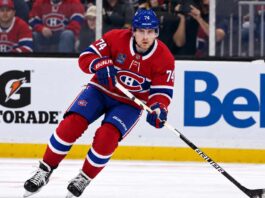 Jake DeBrusk wearing a Montreal Canadiens home jersey and helmet with number 74 in a trade concept image, as NHL rumors connect the Vancouver Canucks forward to Montreal.