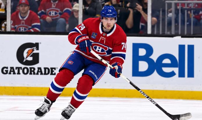 Jake DeBrusk wearing a Montreal Canadiens home jersey and helmet with number 74 in a trade concept image, as NHL rumors connect the Vancouver Canucks forward to Montreal.