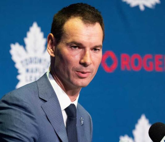 Toronto Maple Leafs general manager John Chayka speaking at a team press conference as Toronto evaluates defensive improvements and potential NHL trades.