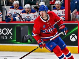 Kirby Dach of the Montreal Canadiens skates past Edmonton Oilers players as NHL trade rumors link Dach to a possible Oilers trade.